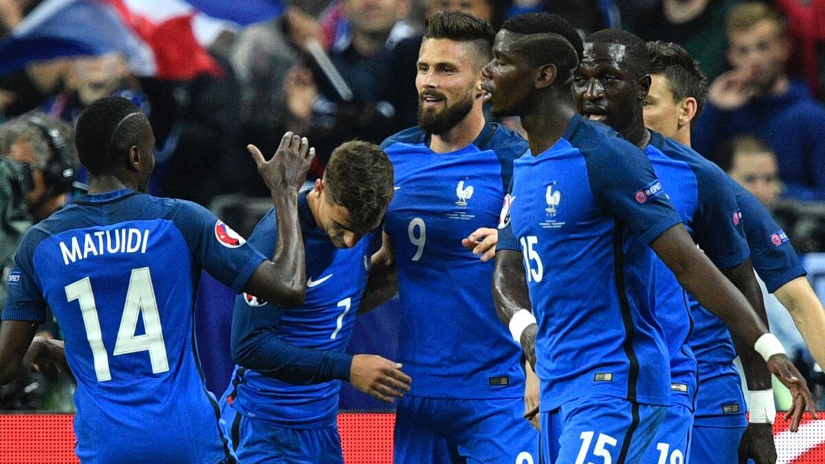 France forward Olivier Giroud (9) is congratulated by teammates after scoring against Iceland on Sunday.