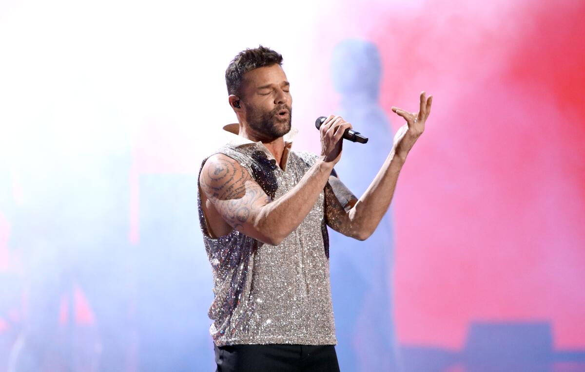 Ricky Martin sings in a sparkling sleeveless shirt