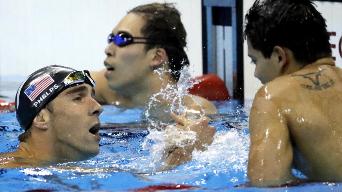 American swimmer Michael Phelps congratulates Singapore's Joseph Schooling for his gold in the men's 100-meter butterfly on Friday.