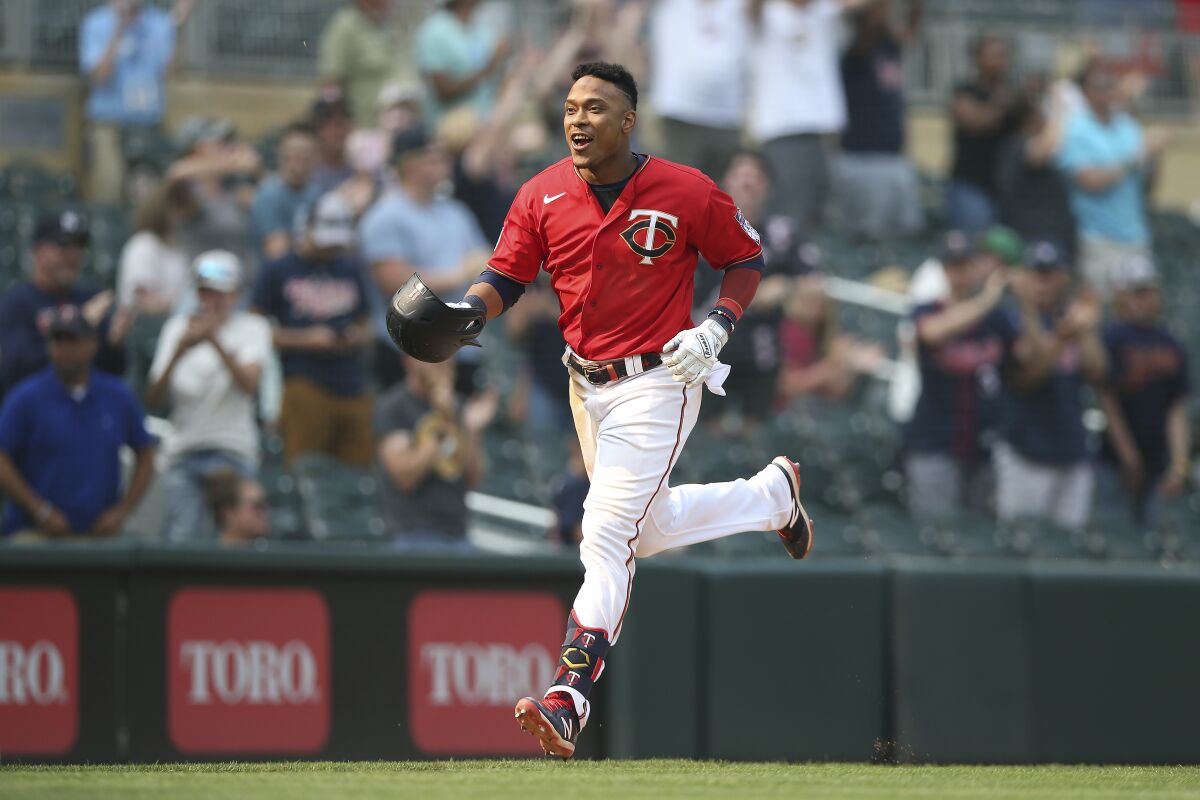 Minnesota Twins' Jorge Polanco runs to home base after hitting a homer to win the game against the Detroit Tigers during the 10th inning of a baseball game Sunday, July 11, 2021, in Minneapolis. (AP Photo/Stacy Bengs)
