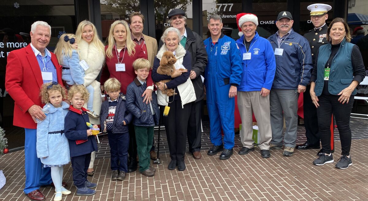 Several parade marshals and officials gather before the La Jolla Christmas Parade & Holiday Festival on Sunday, Dec. 8, 2019. They include ‘Papa’ Doug and Geniya Manchester with their family, Peter and Peggy Preuss and their family, Shane Kimbrough (a NASA astronaut and former International Space Station commander who was the parade’s first 'space' marshal), Gary Krahn, Charles Hartford, Ryan Heritage and event organizer Ann Kerr Bache.