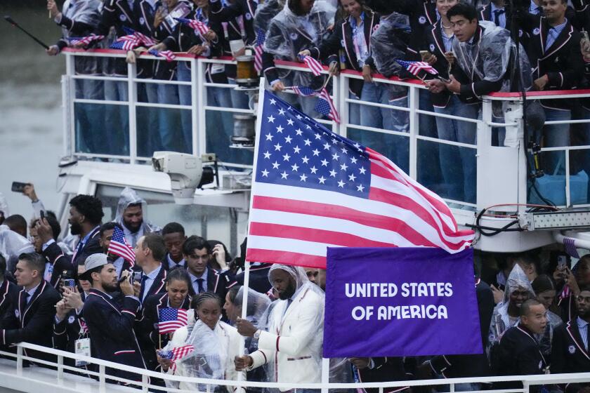 United States' Coco Gauff and Lebron James, bottom center, travel with teammates along the Seine River in Paris, France, during the opening ceremony of the 2024 Summer Olympics, Friday, July 26, 2024. (AP Photo/Kirsty Wigglesworth)