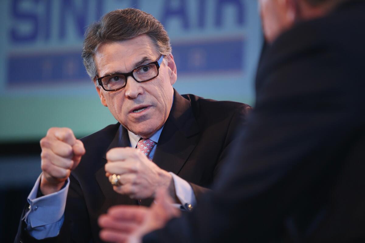 Former Texas Gov. Rick Perry fields questions from Bruce Rastetter at the Iowa Ag Summit on Saturday in Des Moines, Iowa.
