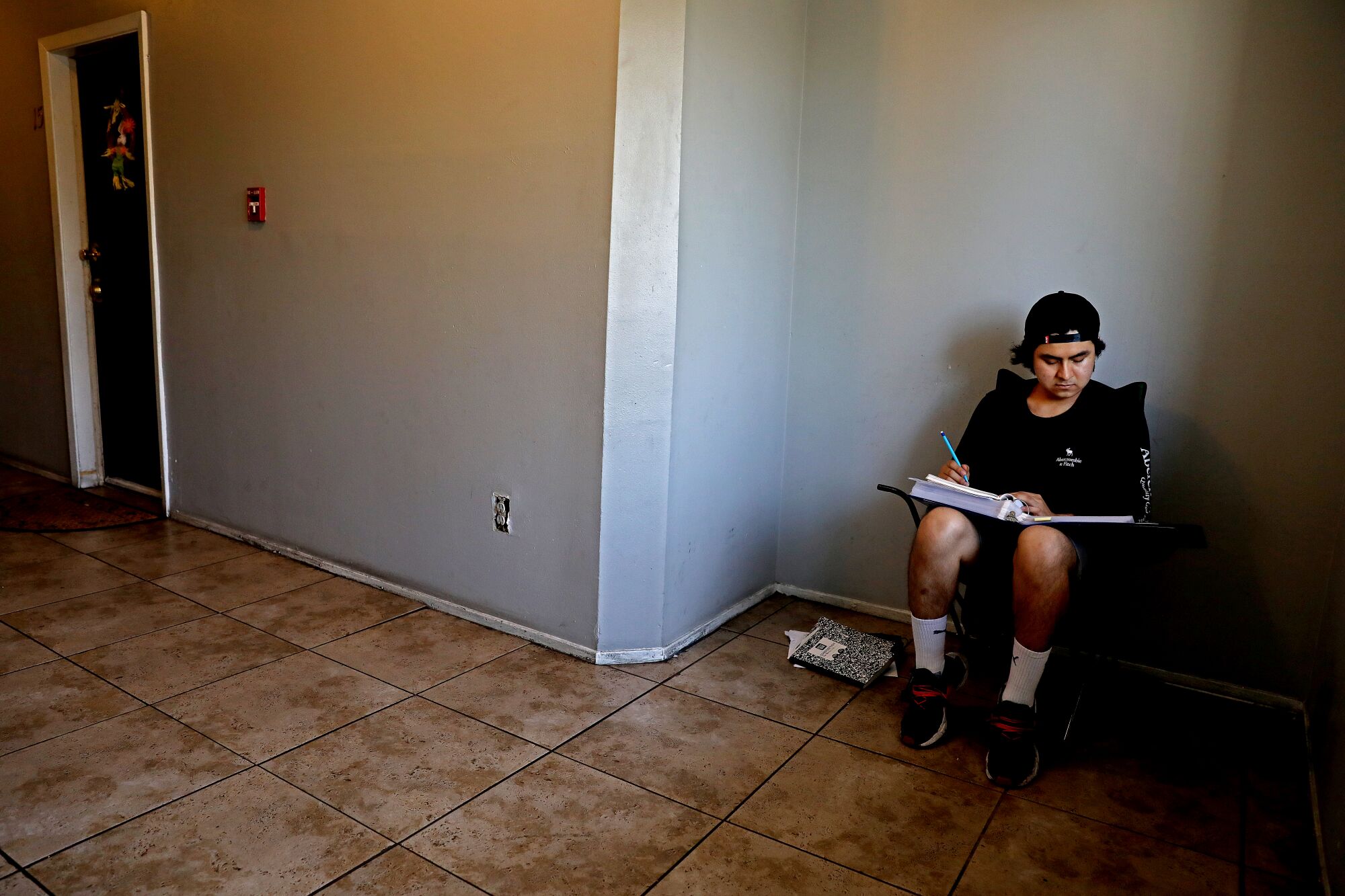 Jesse Iran Davila Garcia, 19, studies for his real estate exam in the hallway