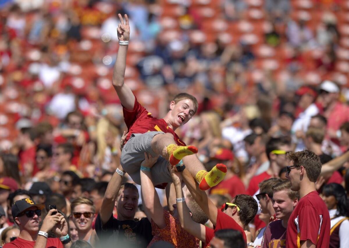 A USC fan is lifted during the Trojans' game against Utah State on Saturday.