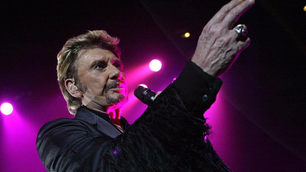 French singer Johnny Hallyday performs in 2003 in Clermont-Ferrand.