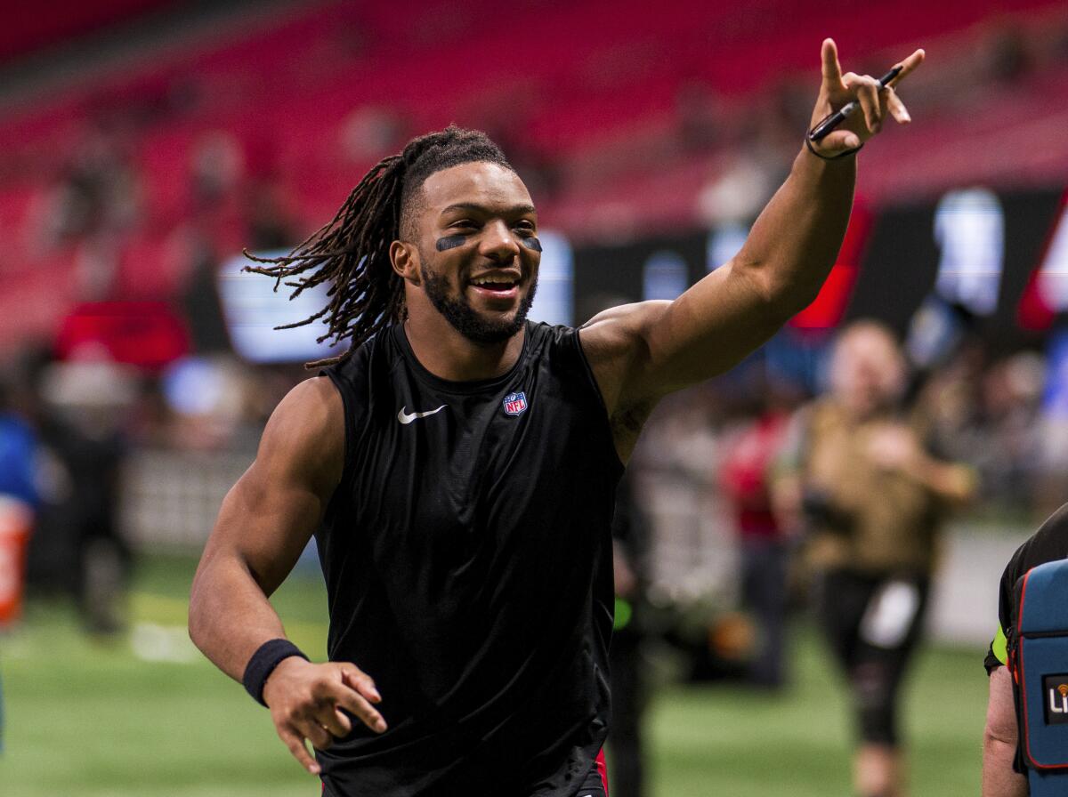 Atlanta Falcons running back Bijan Robinson (7) runs off the field after an NFL football game 