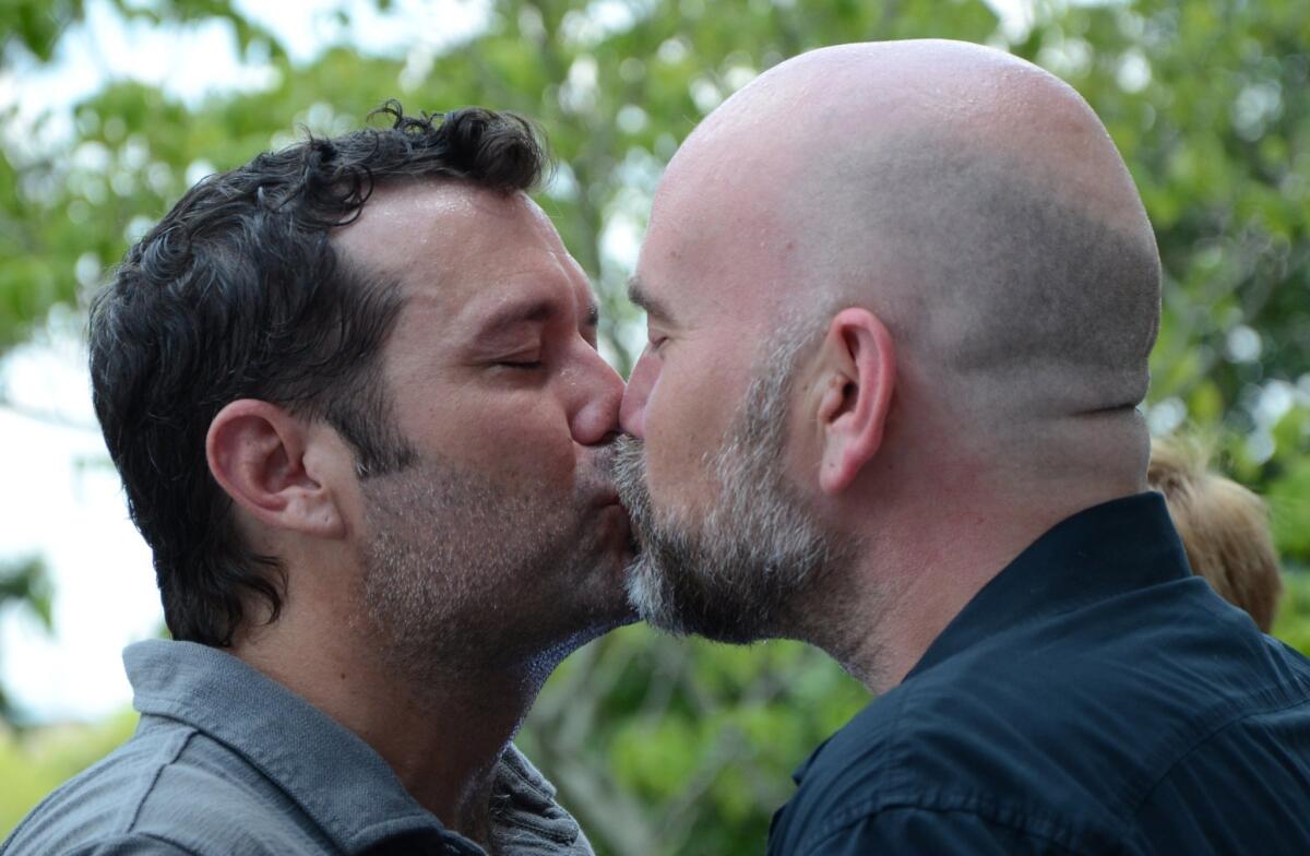 Duane Smith, left, and Knol Aust of Jackson, Miss., kiss in front of the Hinds County courthouse in Jackson during their marriage ceremony on Monday.
