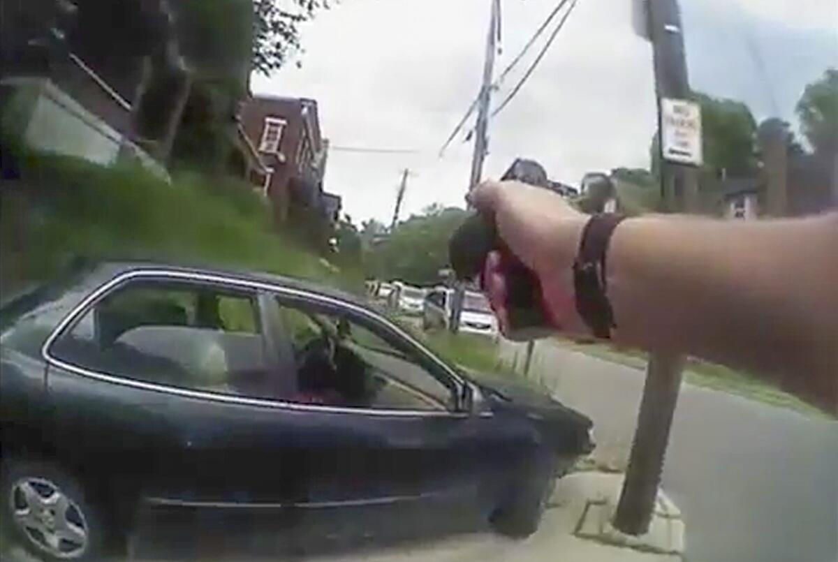 A frame grab from a body-cam video shows University of Cincinnati Police Officer Ray Tensing approaching Samuel DuBose's vehicle right after Tensing shot him during a traffic stop.