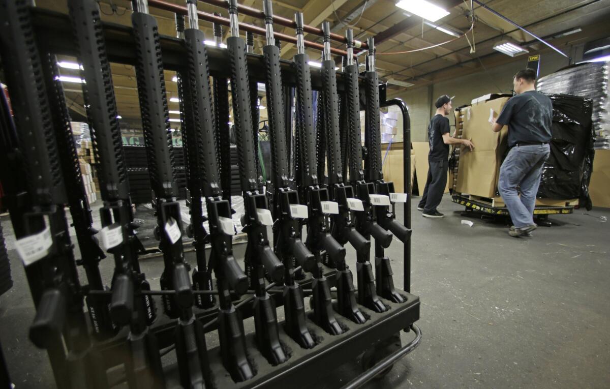 An Orange County sheriff's deputy lost his AR-15 rifle Tuesday after forgetting that he left it on the trunk lid of his car. Above, new AR-15s stand in a rack at Stag Arms in New Britain, Conn., in 2013.