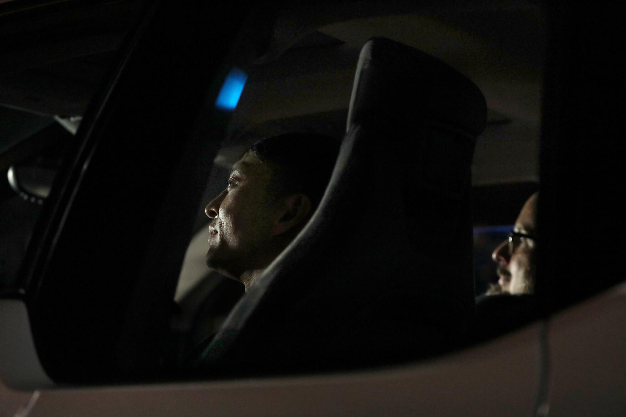 Two men sit in a car