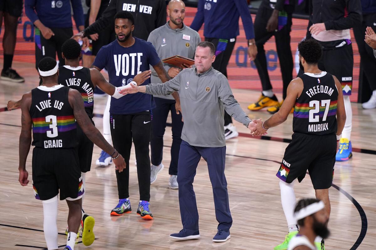 Nuggets coach Michael Malone greets his team during a timeout in the second quarter of Game 3.
