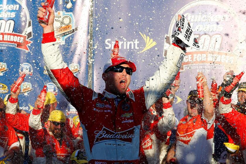 NASCAR driver Kevin Harvick and his Budweiser Chevrolet team celebrate in Victory Lane after winning the Sprint Cup Series race at Phoenix International Raceway on Sunday.