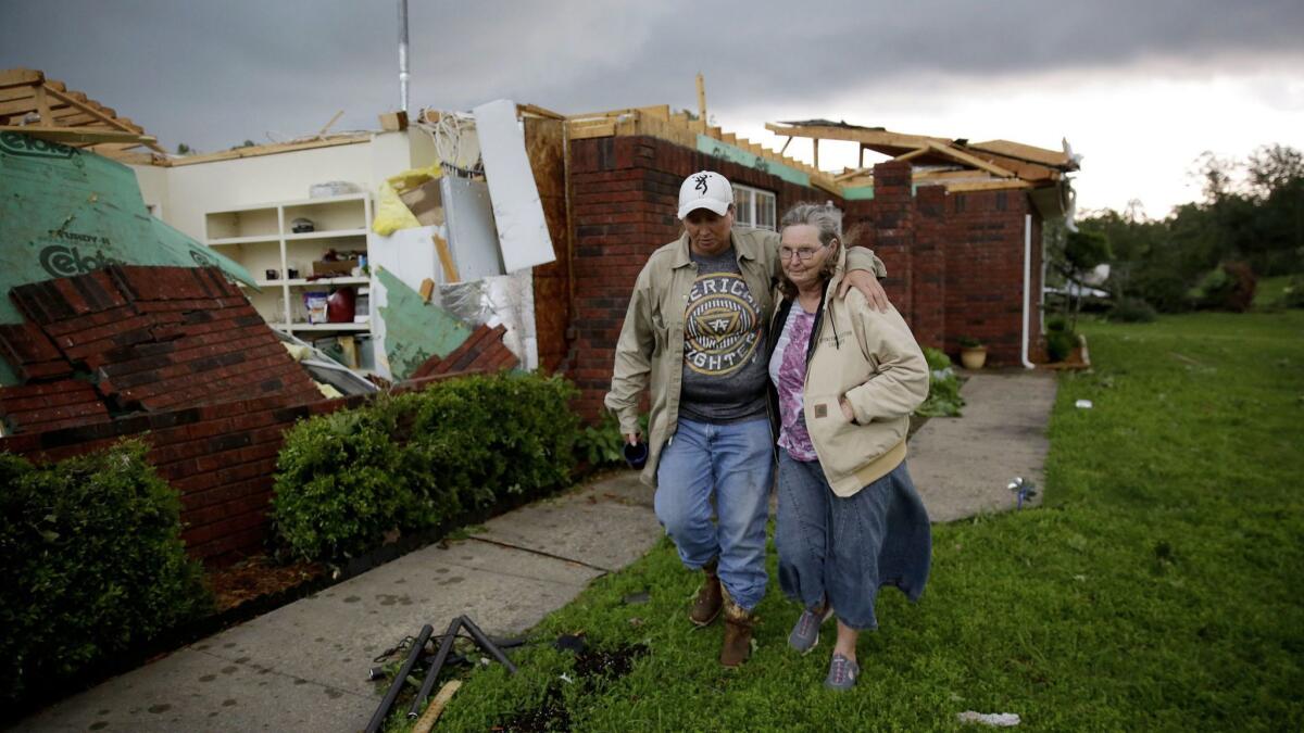 In Peggs, Okla., Karen Spencer is helped to her storm cellar by daughter Tammi Foster on May 21 amid tornado weather.