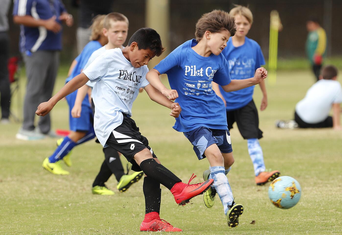 Paularino A's Edwin Salgado, left, and Lincoln B's Finn Mears battle for a ball during a boys' third- and fourth-grade Silver Division game at the Daily Pilot Cup on Wednesday, May 30.