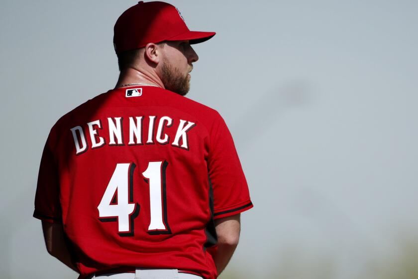 Ryan Dennick prepares to throw a pitch during a spring training workout with the Cincinnati Reds on Feb. 19 in Goodyear, Ariz.