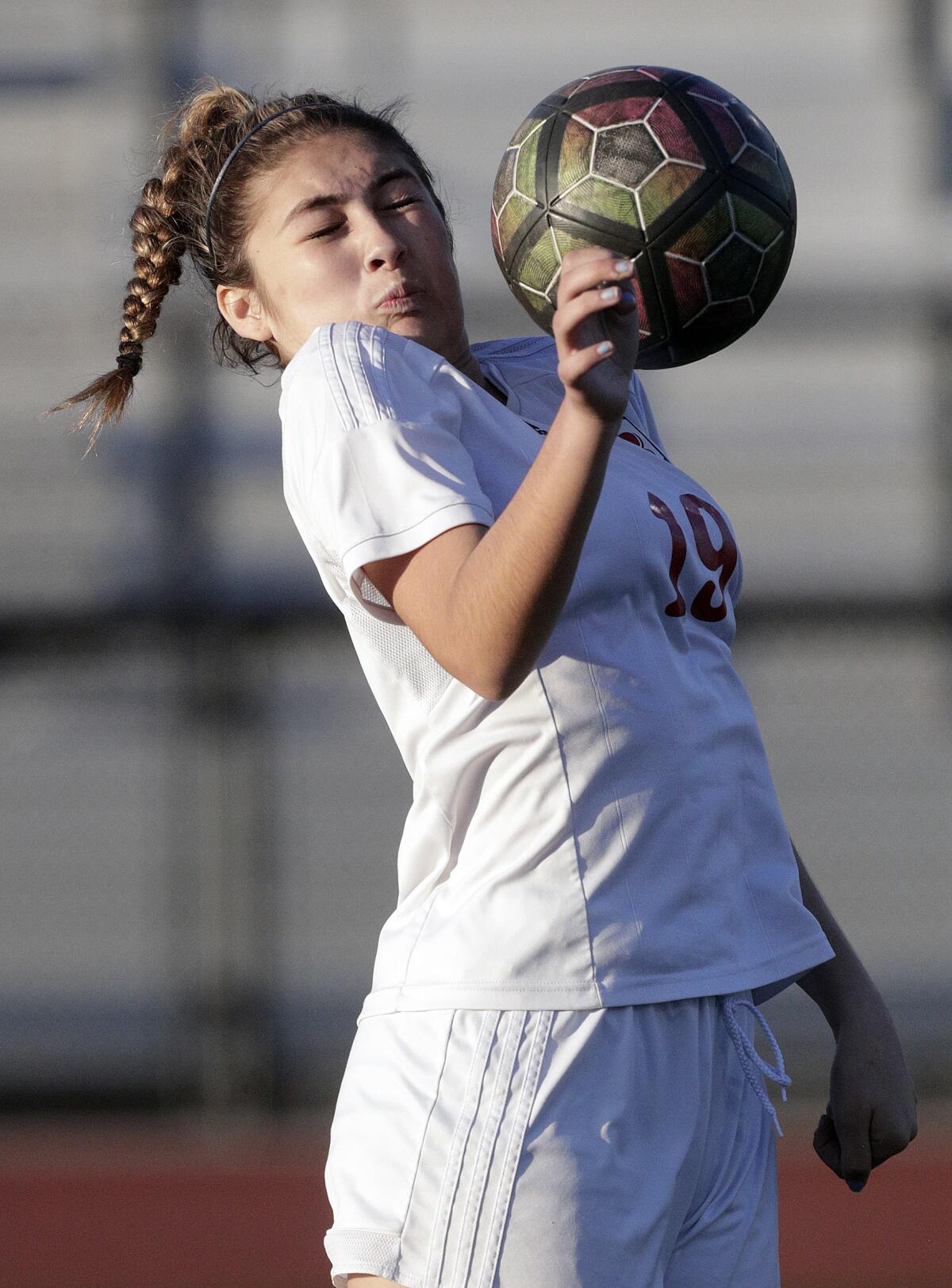Burroughs' Stephanie Torres takes the ball near the face before clearing it from an Arcadia attack in a Pacific League girls' soccer game at Arcadia High School in Arcadia on Tuesday, January 28, 2020.