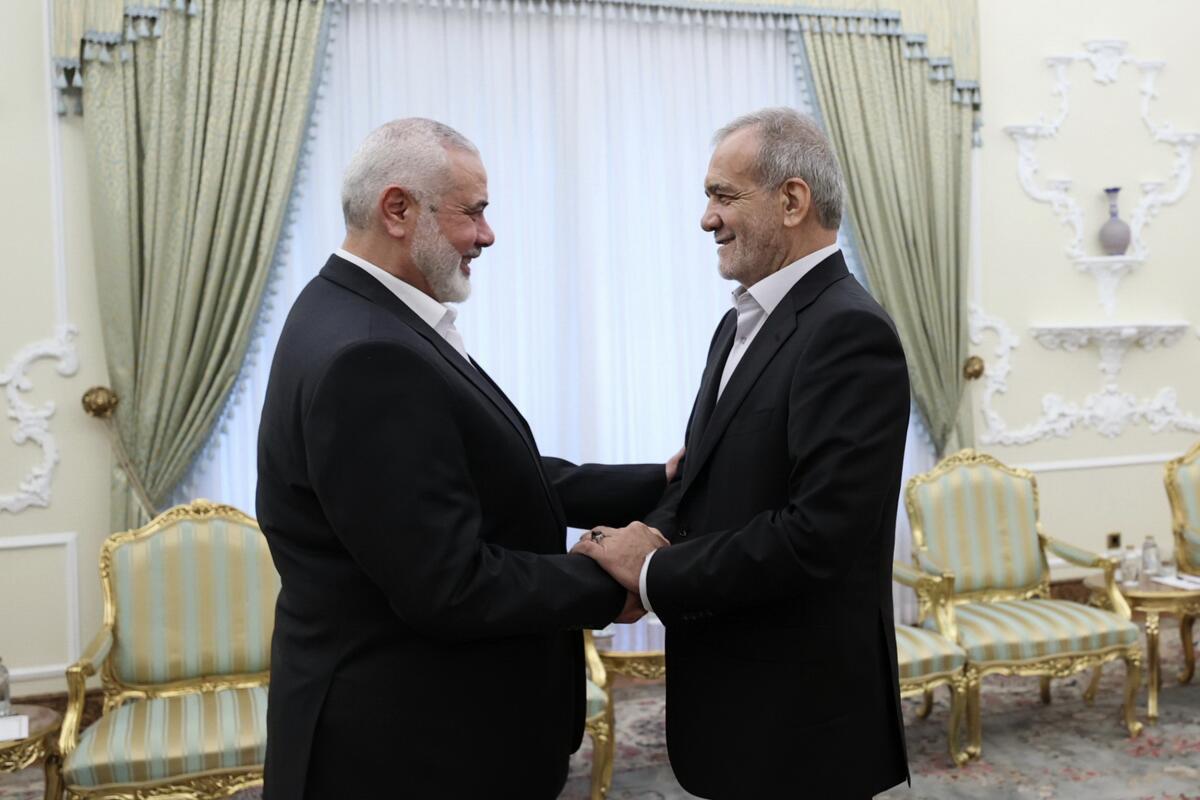 Hamas leader Ismail Haniyeh, left, and Iranian President Masoud Pezeshkian