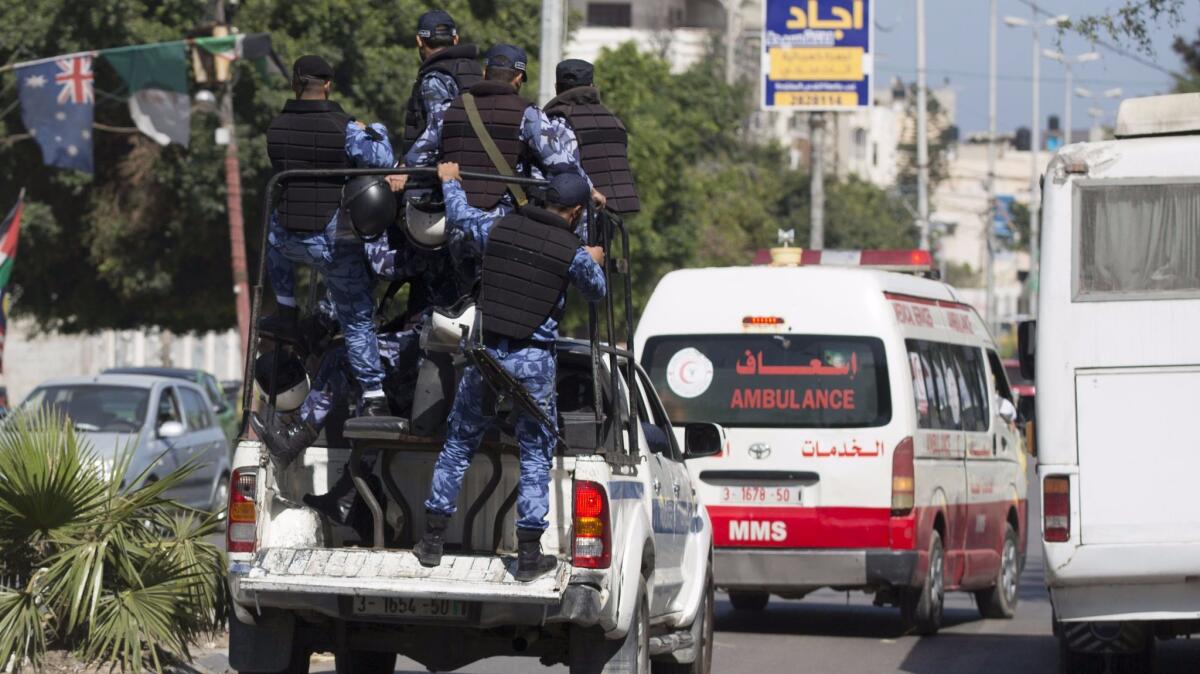 Hamas police secure the area as an ambulance reportedly carrying the bodies of men accused of collaborating with Israel leaves the main police building in Gaza City on Thursday.