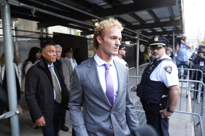 Daniel Penny, right, charged with manslaughter for placing a man in a deadly chokehold aboard a New York City subway train, departs Manhattan Criminal Court, Thursday, Oct. 3, 2024, in New York. (AP Photo/Pamela Smith)