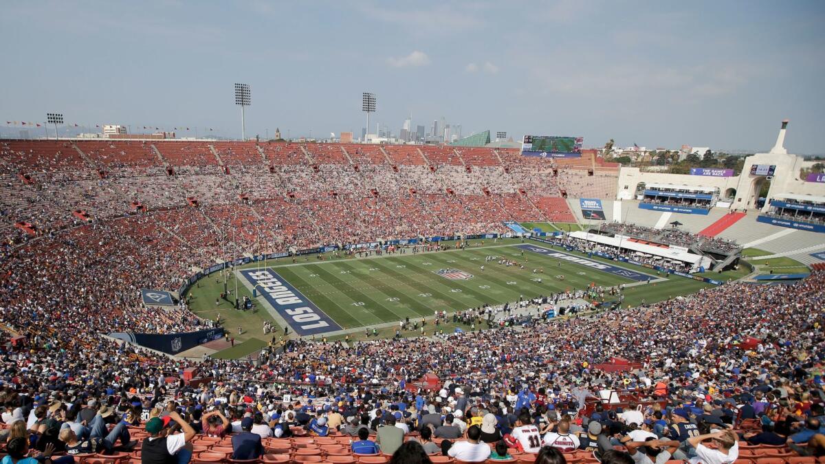 Fans watch the Rams play the Washington Redskins at the Coliseum on Sept. 17.