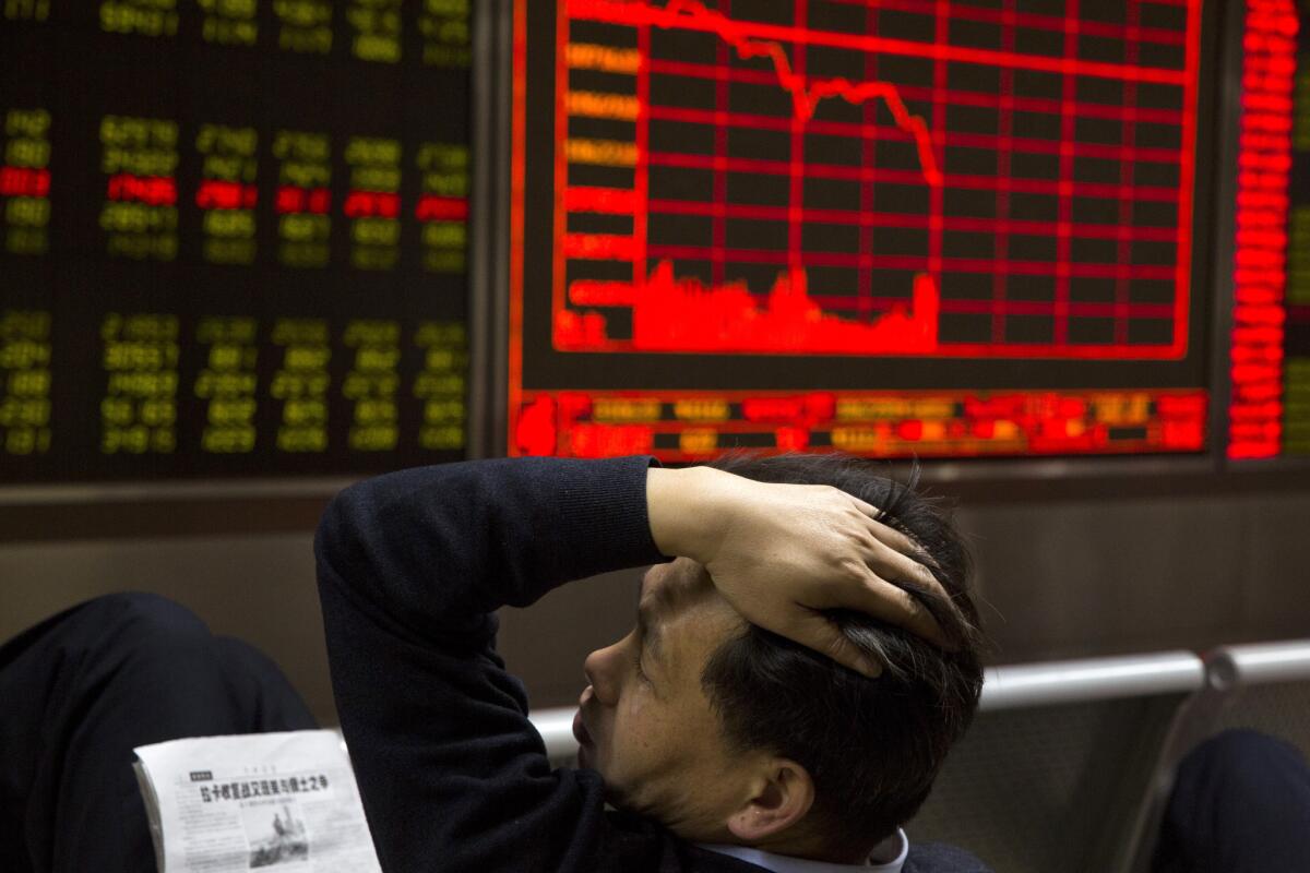A Chinese man reacts near a board showing the Shanghai Stock Exchange Composite Index at a brokerage in Beijing, China, Wednesday, Nov. 9, 2016.