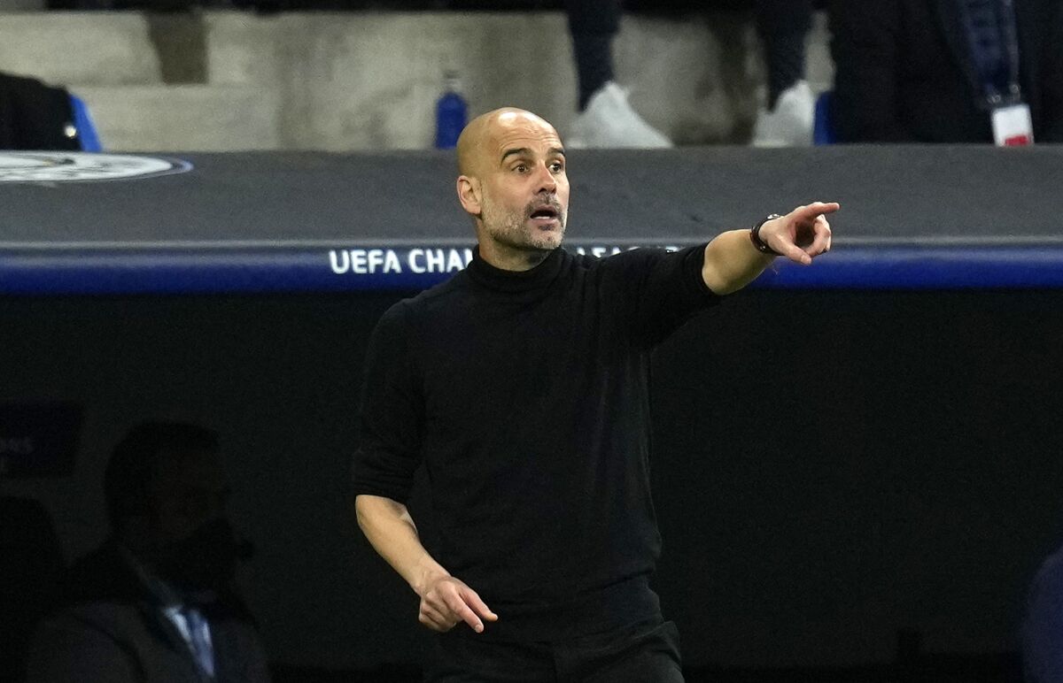 Manchester City's head coach Pep Guardiola gives instructions to his players during the Champions League semi final, second leg soccer match between Real Madrid and Manchester City at the Santiago Bernabeu stadium in Madrid, Spain, Wednesday, May 4, 2022. (AP Photo/Manu Fernandez)