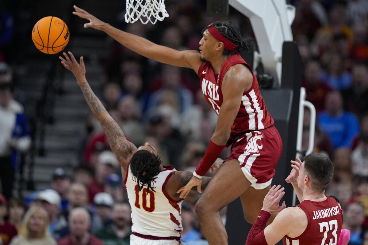 Washington State forward Isaac Jones (13) blocks the shot of Iowa State guard Keshon Gilbert (10) in the first half of a second-round college basketball game in the NCAA Tournament, Saturday, March 23, 2024, in Omaha, Neb. (AP Photo/Charlie Neibergall)