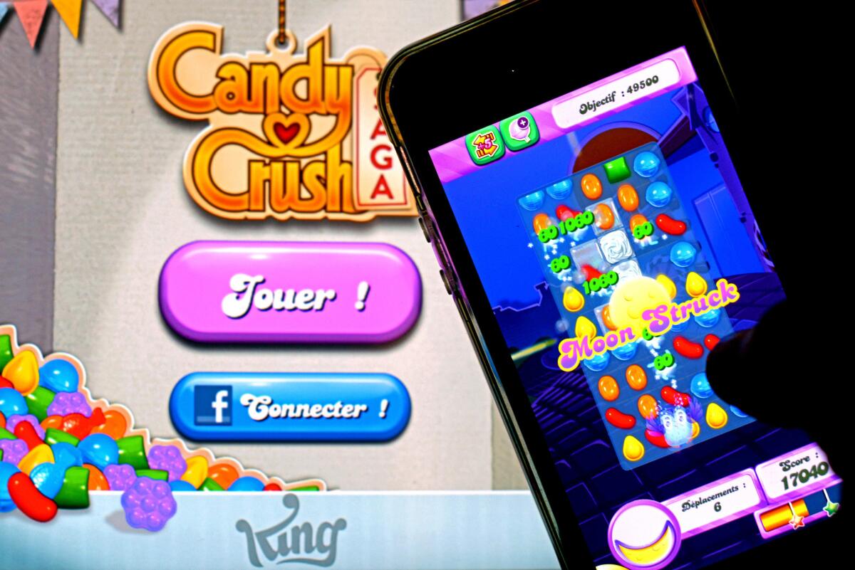 A man plays "Candy Crush Saga," one of the biggest moneymaking mobile games, on his iPhone.
