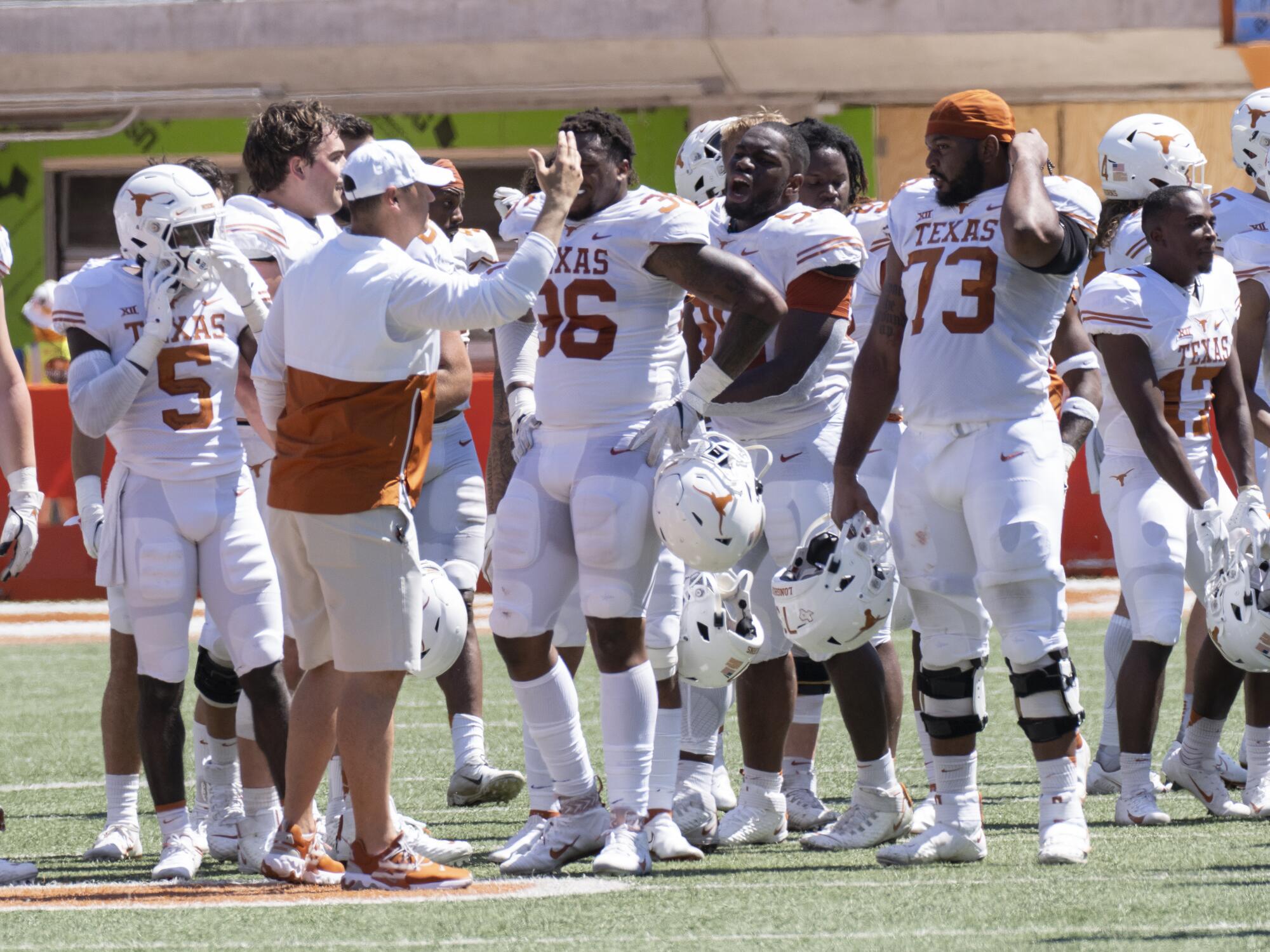 Texas coach Steve Sarkisian huddles with his team after its spring game. 