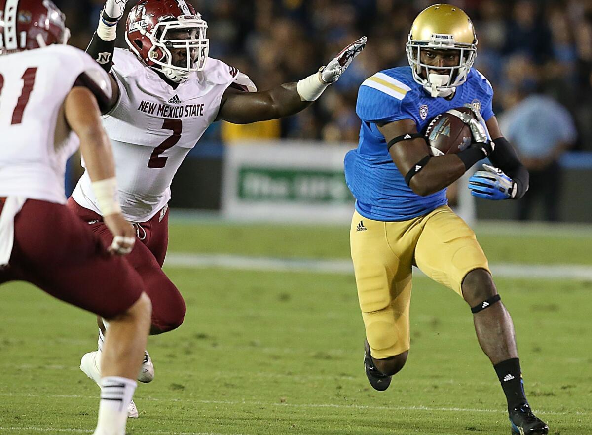 UCLA wide receiver Devin Fuller gets a big gain after catching a pass from quarterback Brett Hundley against New Mexico State at the Rose Bowl on Saturday.