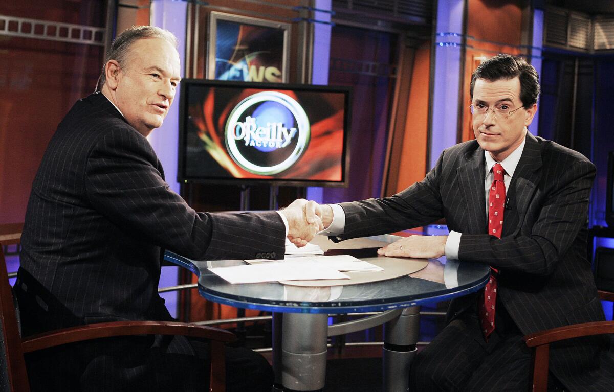 Bill O'Reilly, left, welcomes Stephen Colbert, then host of Comedy Central's "The Colbert Report." to the set of the Fox News show "The O'Reilly Factor" in 2007.