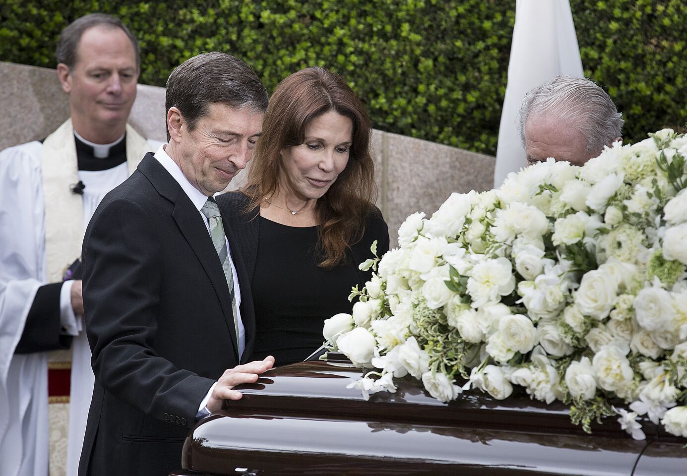 Ron Reagan, second from left, and his sister, Patti Davis, pause at their mother Nancy Reagan's casket at her gravesite at the Ronald Reagan Presidential Library in Simi Valley.
