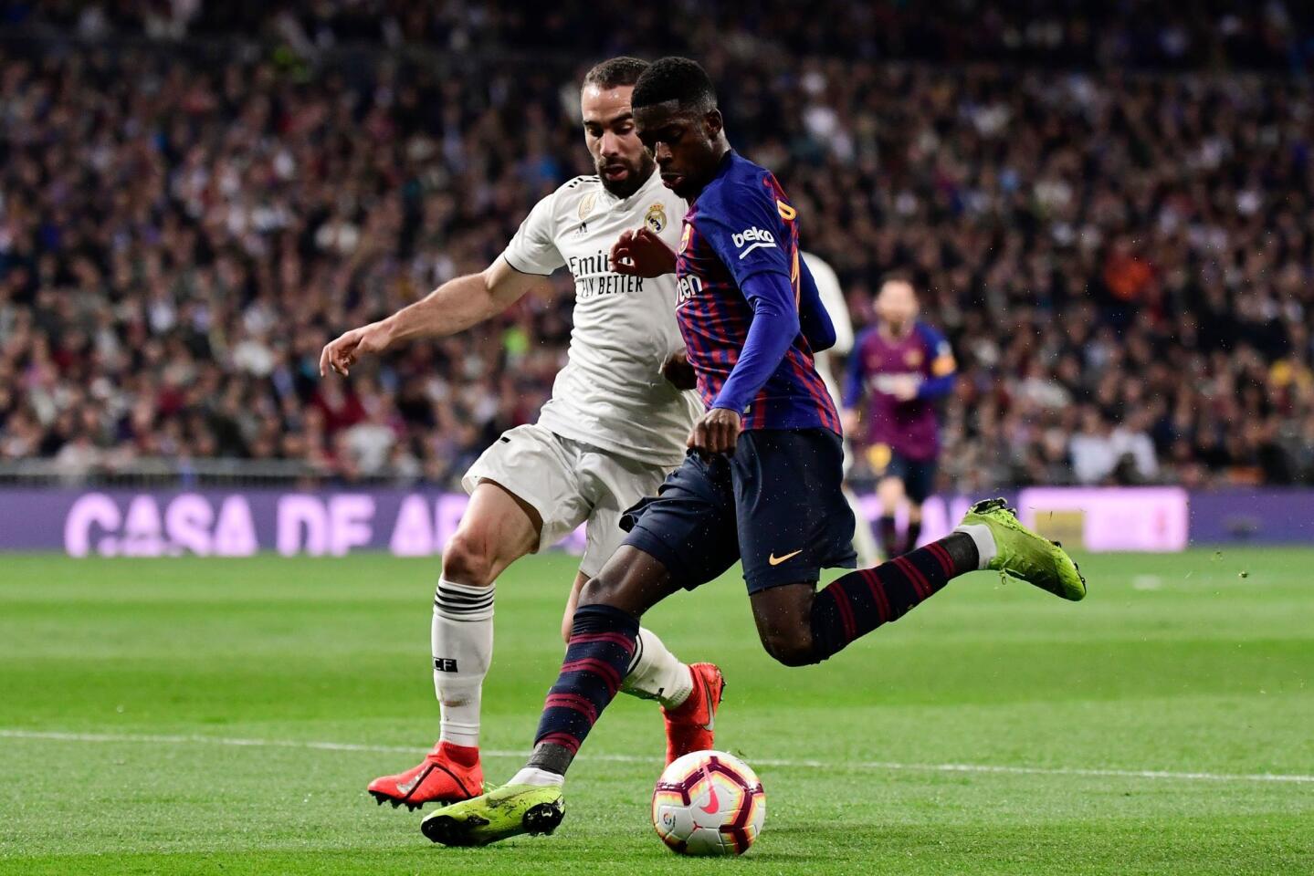Barcelona's French forward Ousmane Dembele (R) challenges Real Madrid's Spanish defender Dani Carvajal during the Spanish league football match between Real Madrid CF and FC Barcelona at the Santiago Bernabeu stadium in Madrid on March 2, 2019. (Photo by JAVIER SORIANO / AFP)JAVIER SORIANO/AFP/Getty Images ** OUTS - ELSENT, FPG, CM - OUTS * NM, PH, VA if sourced by CT, LA or MoD **