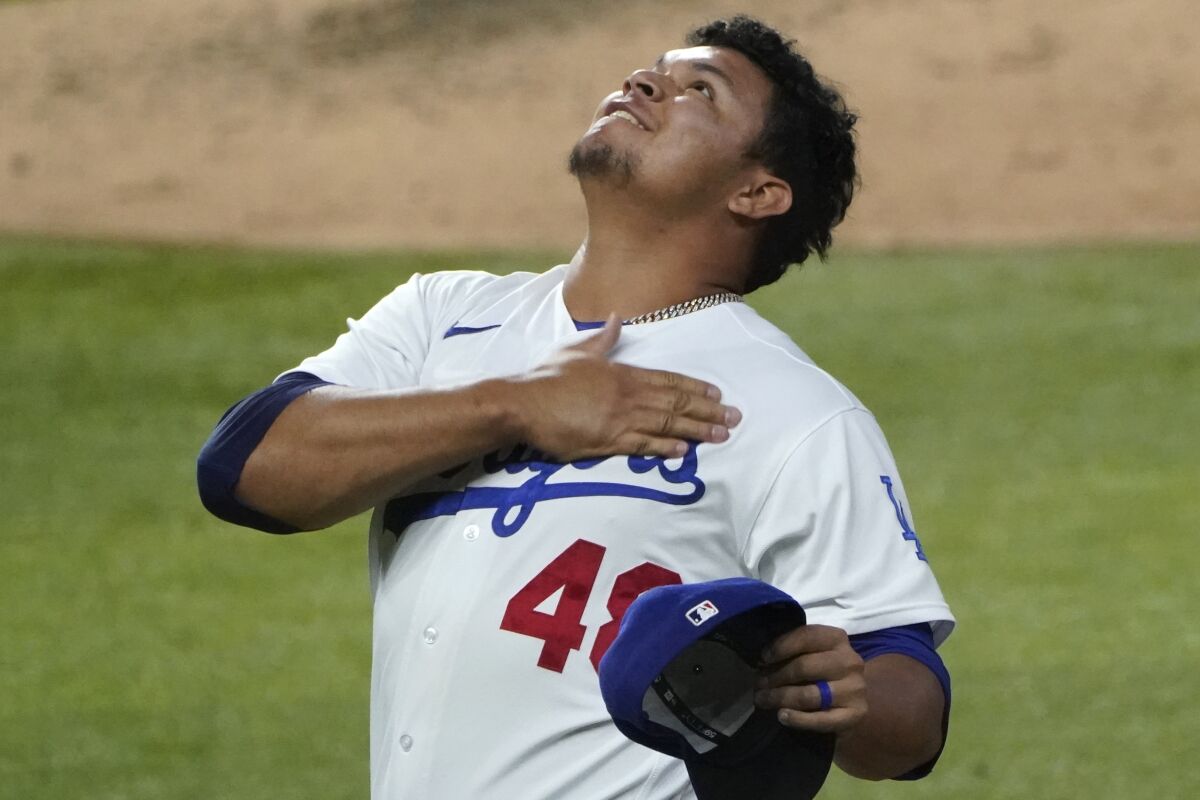 Dodgers relief pitcher Brusdar Graterol celebrates after a catch by Cody Bellinger 
