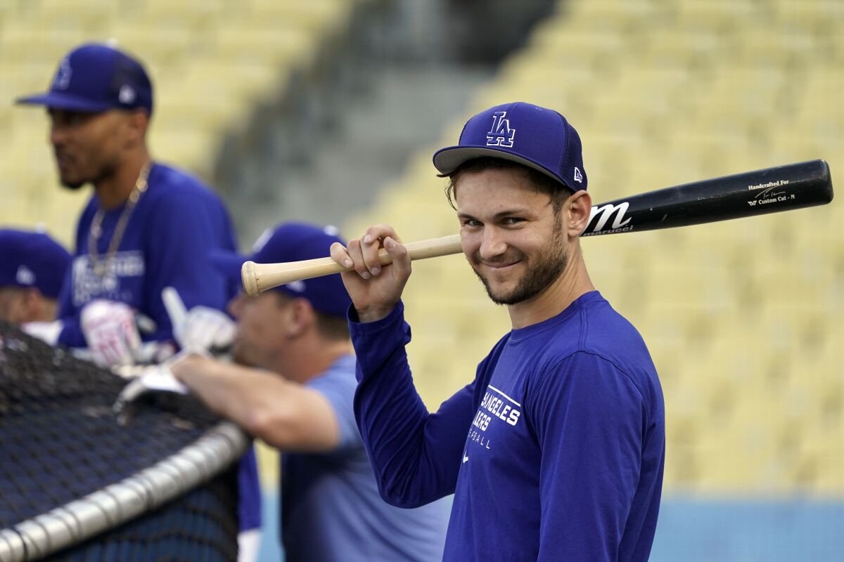 Dodgers' Trea Turner, right, smiles while taking batting practice before Game 1 of the NLDS.