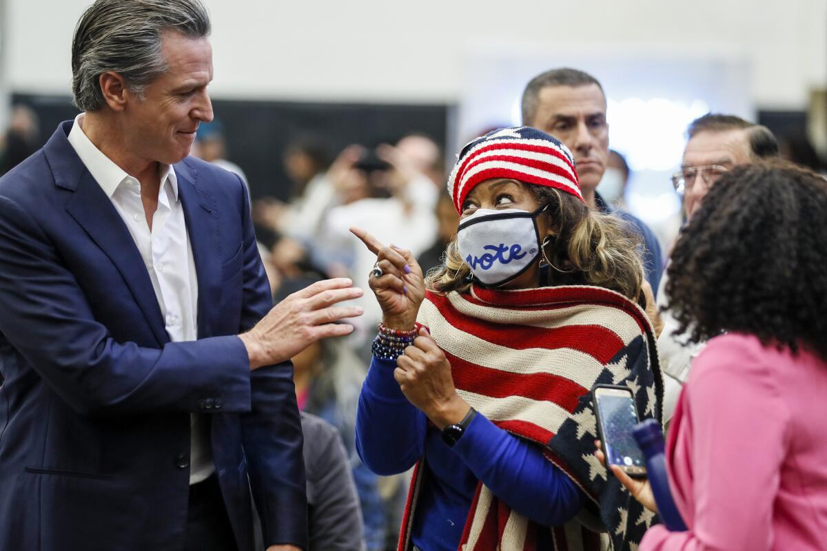 Dr. Jennifer Robinson chats with Gov. Newsom at a rally  at Long Beach City College.