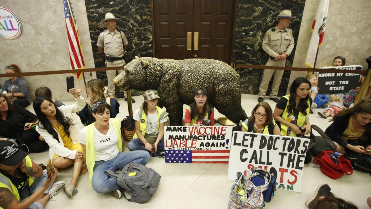 Opponents of a bill to give the state more oversight of doctors who exempt children from vaccinations sit outside the governor's office after the Assembly Health Committee advanced the bill Thursday in Sacramento. New data show the vaccination rate has dropped.