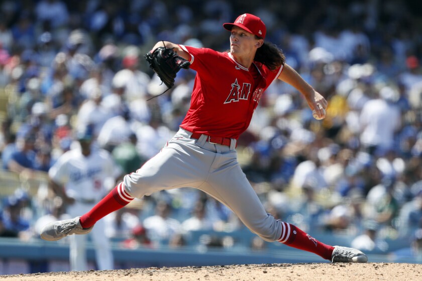 Angels relief pitcher Packy Naughton throws to a Dodgers batter.