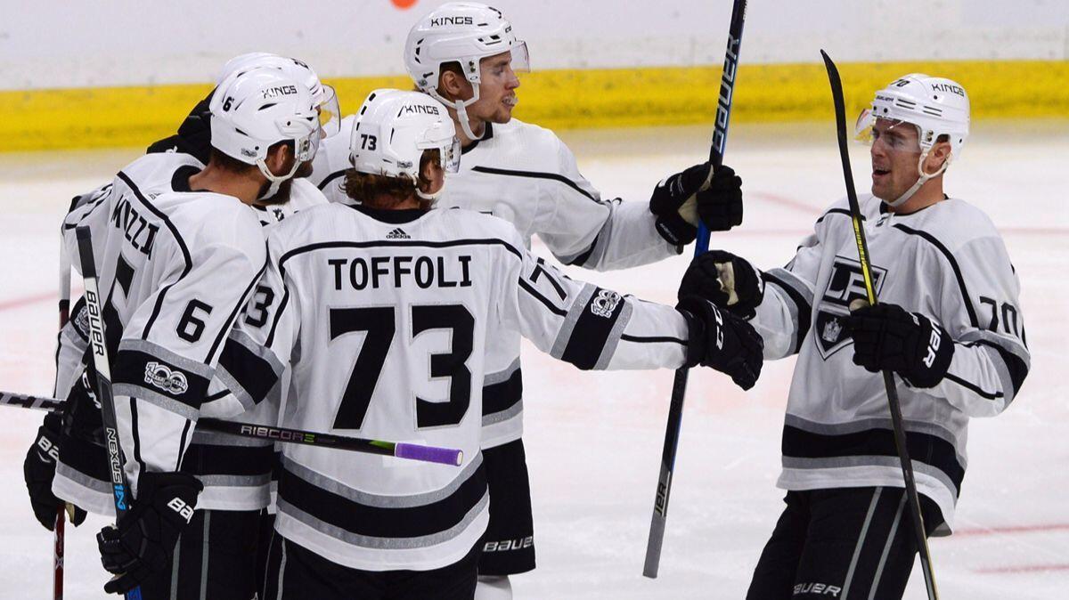 Kings players celebrate a first-period goal against the Ottawa Senators on Tuesday.