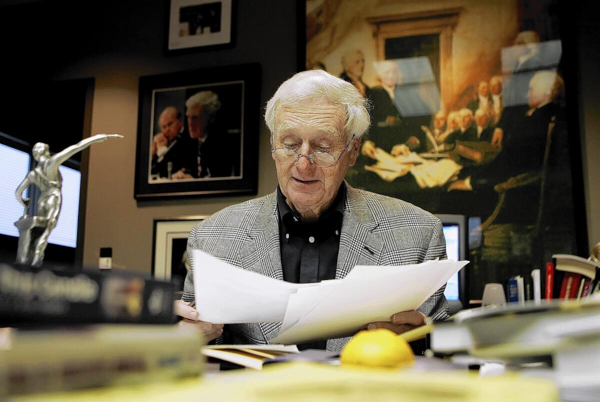 John Seigenthaler works in his office at the Tennessean newspaper in Nashville in 2005. The maverick journalist, who helped shape USA Today and championed civil rights, died Friday at the age of 86.