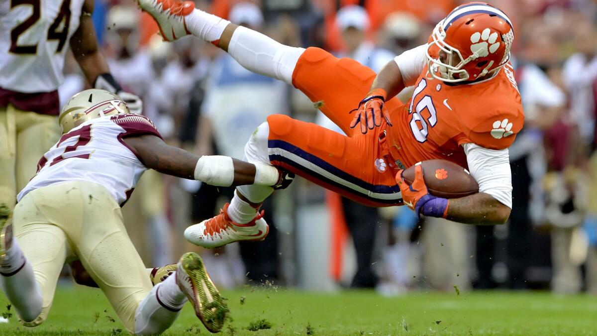 Clemson receiver Jordan Leggett is upended by by Florida State defensive back Lamarcus Brutus during the first half Satuday.