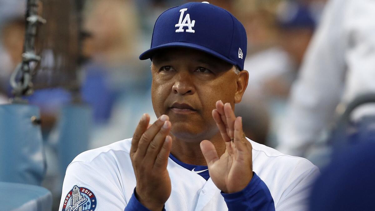 Dodgers manager Dave Roberts in the dugout during a game against the Cardinals.