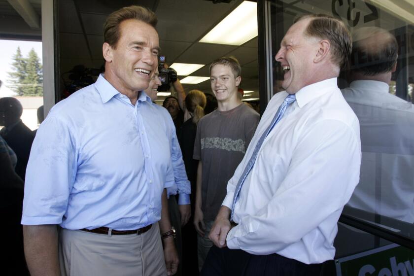 Duf Sundheim, right, smiles with Arnold Schwarzenegger, then California governor, at the July 2006 opening of an office for Schwarzenegger's reelection campaign in Mountain View, Calif.