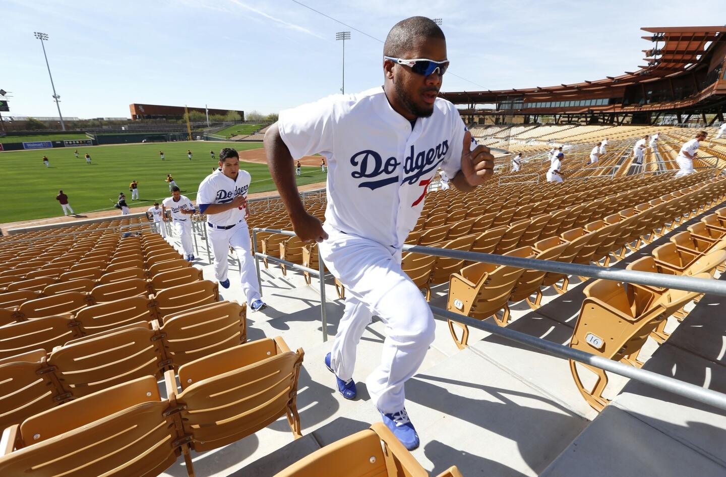Pitcher Kenley Jansen leads a group running stairs at the Camelback Ranch ballpark and player development facility in Glendale, Ariz.
