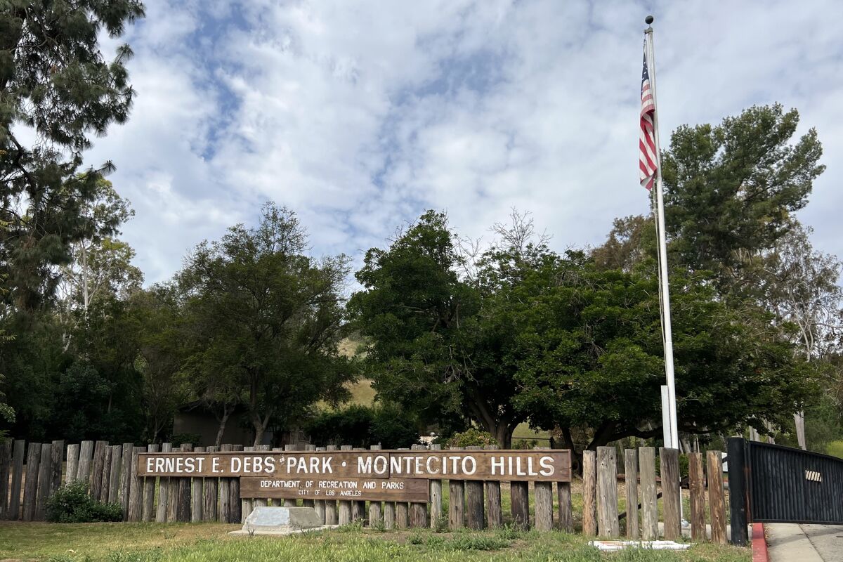 A wooden sign reads "Ernest E. Debs Park - Montecito Hills."