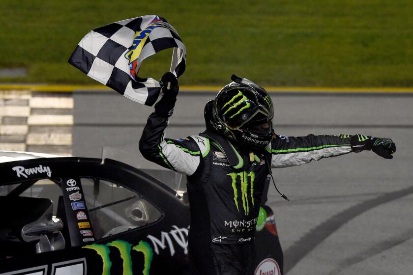 Kyle Busch celebrates with the checkered flag after winning the NASCAR Xfinity Series FURIOUS 7 300 at Chicagoland Speedway on Saturday.