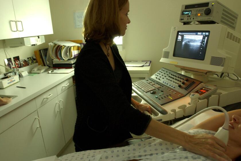 National Cancer Institute researchers have forecast an increase of up to 50% in U.S. breast cancer cases between 2011 and 2030. Here, a Los Angeles-area doctor demonstrates how she performs a breast ultrasound.