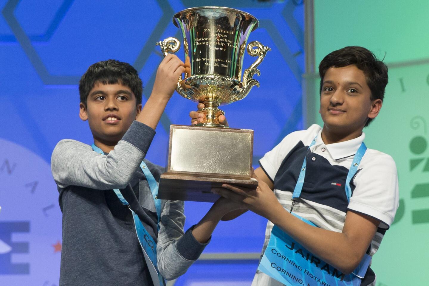 Nihar Saireddy Janga, left, of Austin, Texas, and Jairam Jagadeesh Hathwar, of Corning, N.Y., hoist the trophy after being declared co-champions at the 2016 Scripps National Spelling Bee in National Harbor, Md., on May 26, 2016.