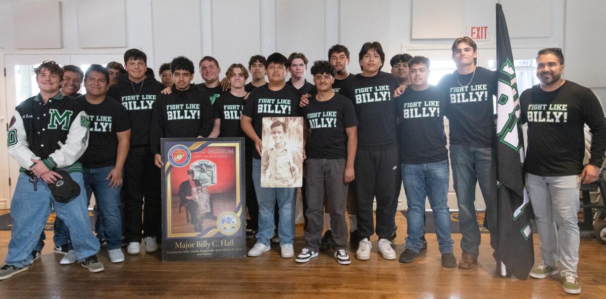 The Costa Mesa High football team attends a ceremony in memory of Major Billy Hall in Newport Beach on Friday.
